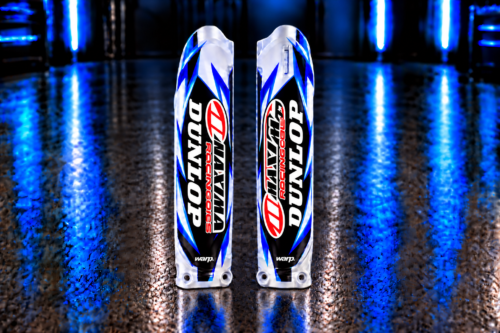 Pair of custom blue, cyan, black and white fork guard decals with Dunlop, Maxima and WARP example logos; plastic fork guards not included
