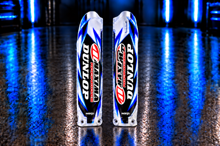 Pair of custom blue, cyan, black and white fork guard decals with Dunlop, Maxima and WARP example logos; plastic fork guards not included